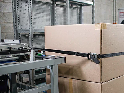 Double sided filament tape securing cargo for transport